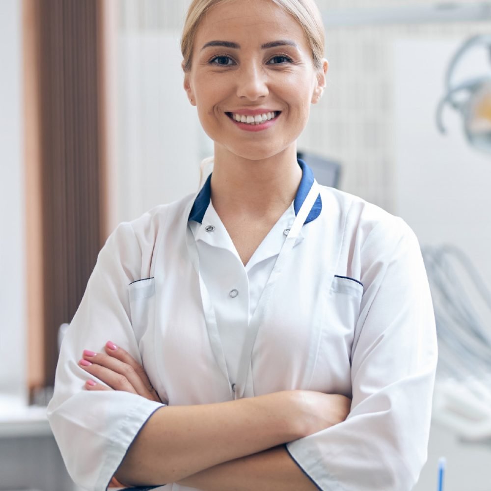 cheerful-beautiful-dentist-waiting-for-patients-in-SXC8H85.jpg